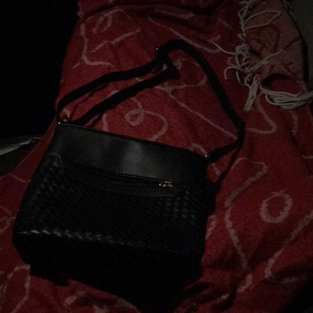 Black crossbody with textured front and front zipper and zipper top